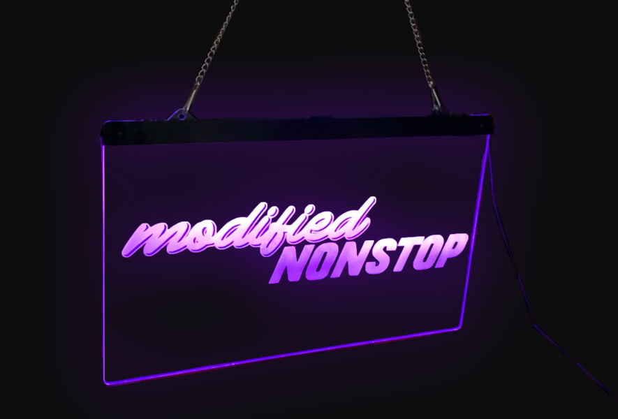 Acrylic etched LED sign reading "modded stop", hanging against a dark background