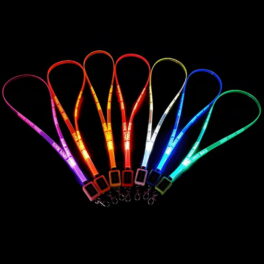 Seven LED lanyards lined up in a dark room glowing pink, orange, yellow, red, white, blue, and green with custom logo laser engraved onto them
