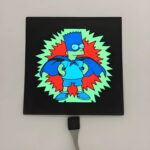 Bart Simpson super hero design lighting up on black EL panel in light setting