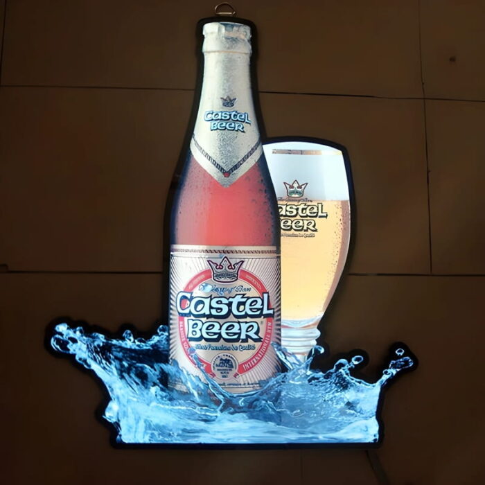 Poster Of Castel Beer bottle and glass with splash effect lighting up brightly in dark setting