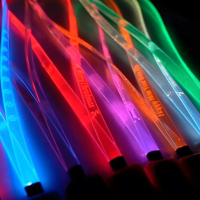 Close up on custom engraved LED lanyards in rainbow colors