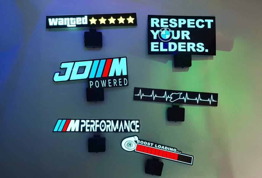 A collection of illuminated signs stating "Respect Your Elders," featuring light-up panels powered by battery packs.