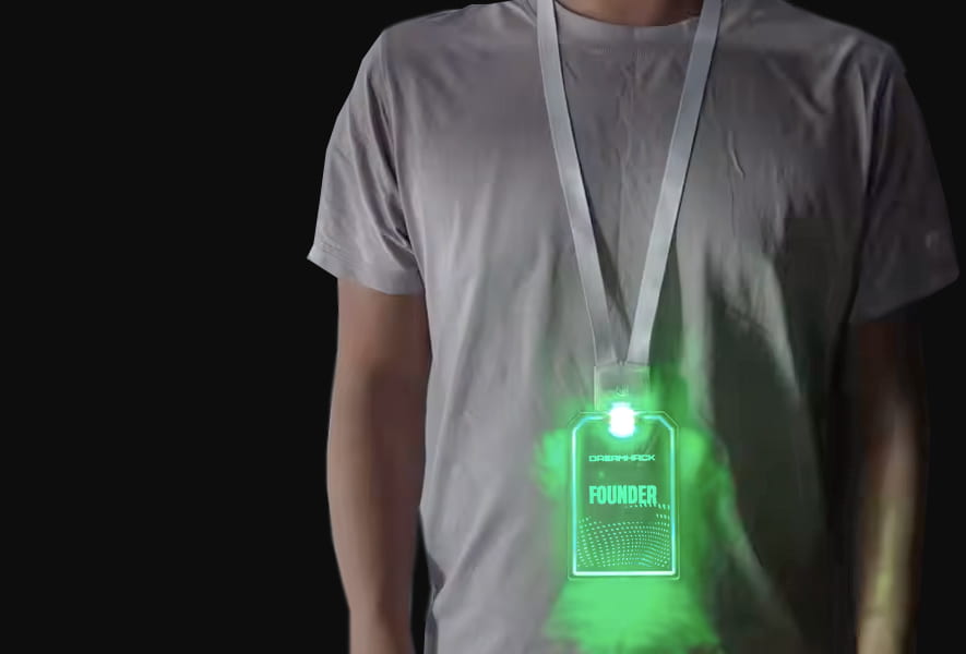 A man with a bright green light up badge on a nylon lanyard
