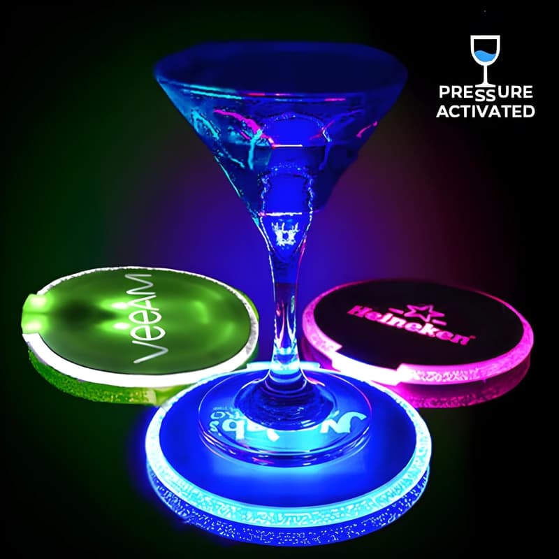 3 glowing LED coasters with different designs illuminating neon colors blue