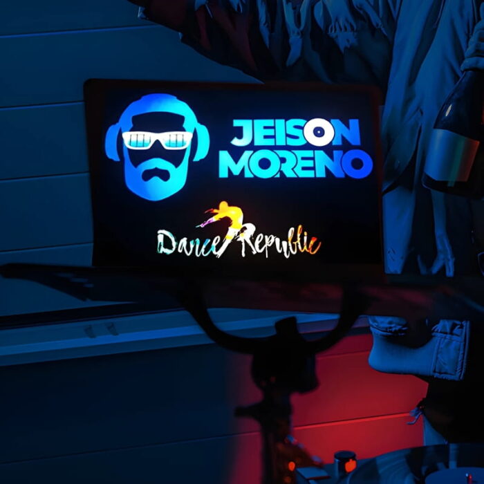 Custom DJ logo with name and design lighting up brightly on back of laptop