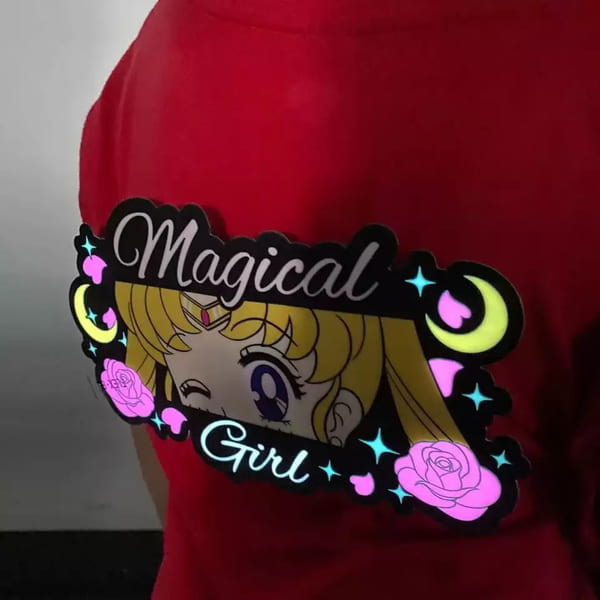 A girl sporting a red t-shirt with a glowing panel that says "magical girl."