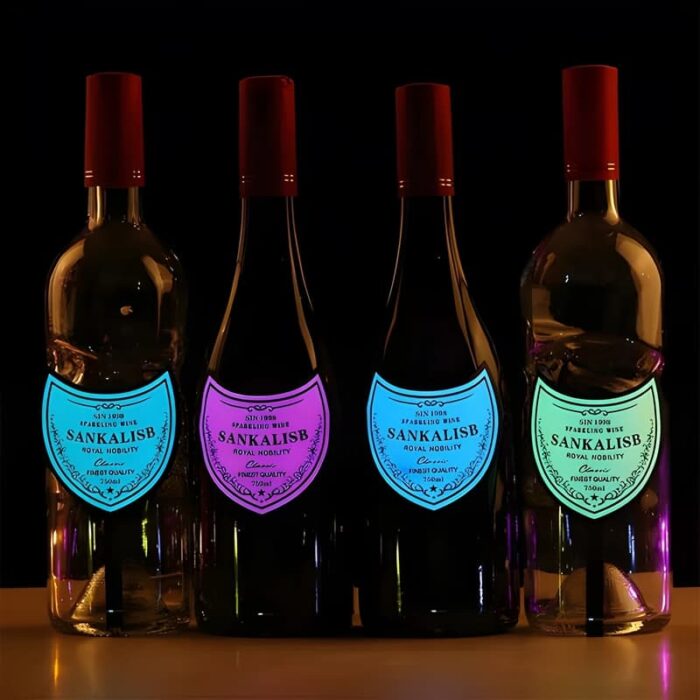 Four wine bottles in a row each with their own brightly lit up neon EL panel label