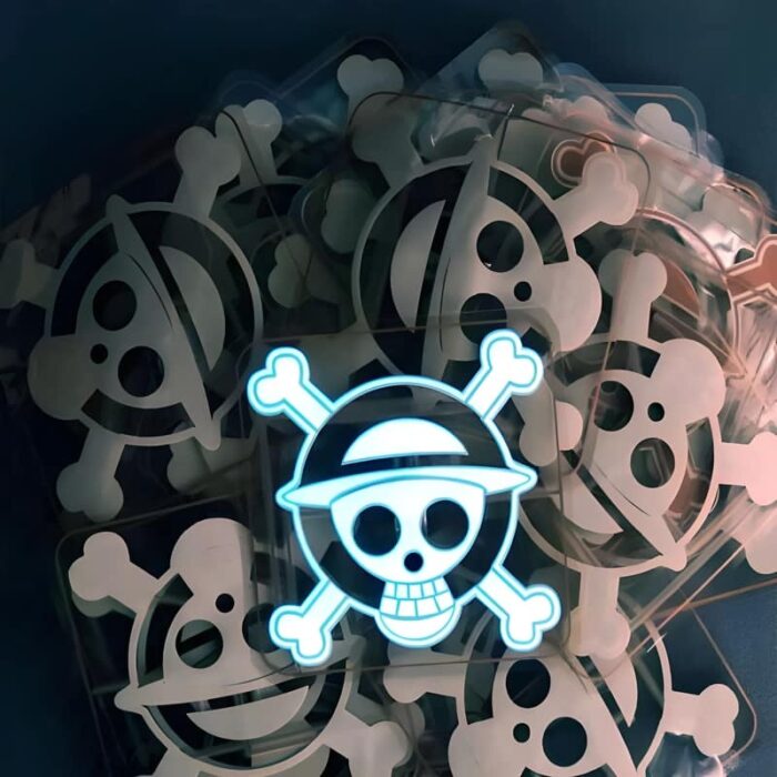 Pile of EL panels with skull design and transparent background, with one skull in the center fully lit up