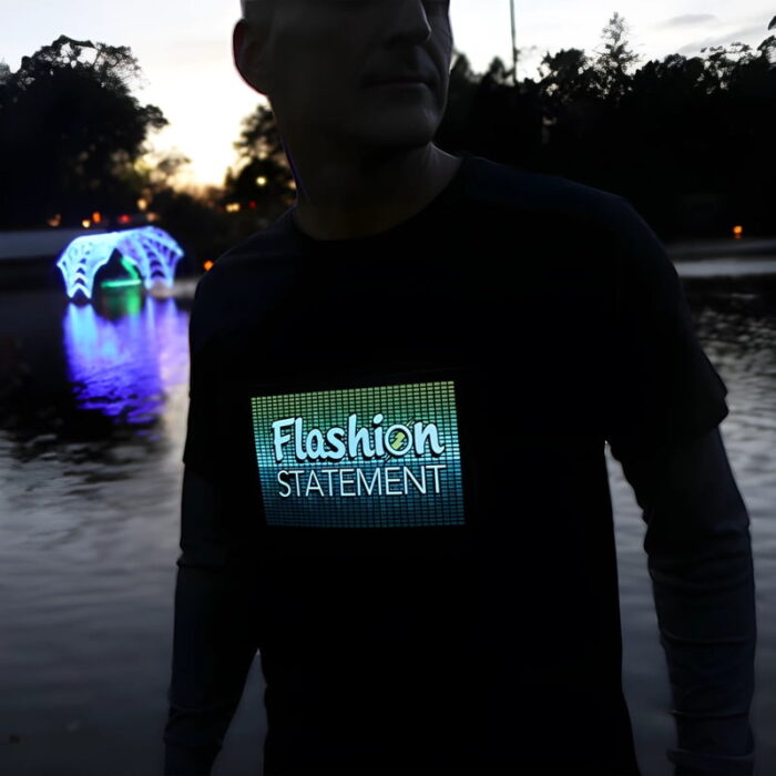 Man wearing Flashion Statement custom LED t-shirt outside with Christmas lights in the background