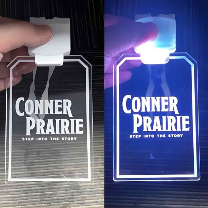 Conner prairie laser engraved logo on acrylic ID badge turned off on left side turned on on right side