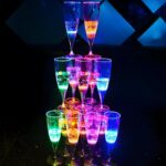 Stacked tower of LED champagne flutes lighting up bright neon colors