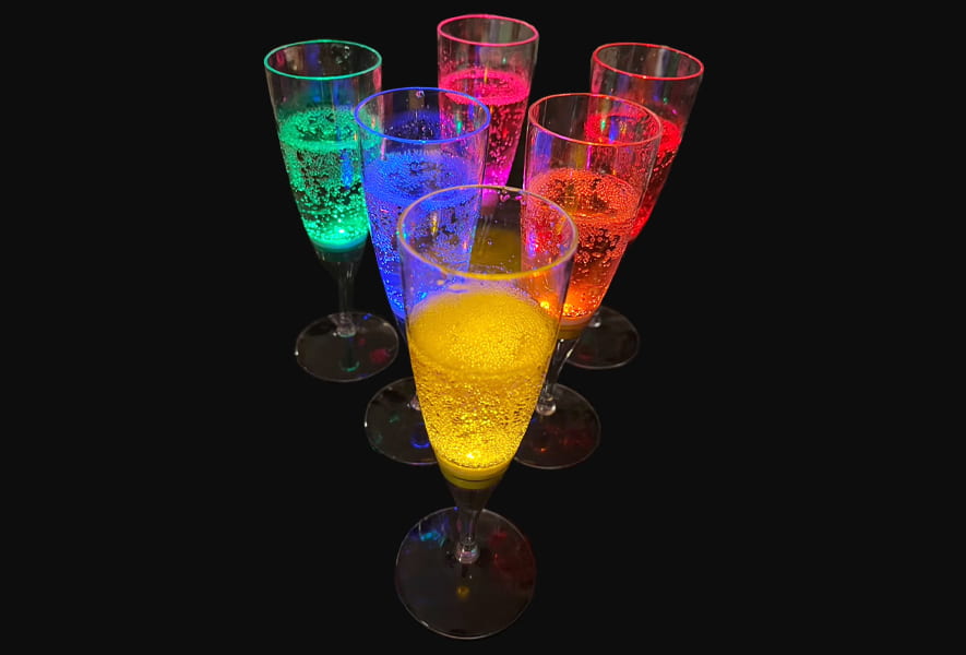 Colorful LED-lit champagne flutes with liquid inside, creating a bright and celebratory atmosphere