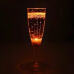 Orange LED champagne flute lighting up bright orange