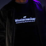 Close up of light up shirt for IT company lighting up like an equalizer under leather jacket