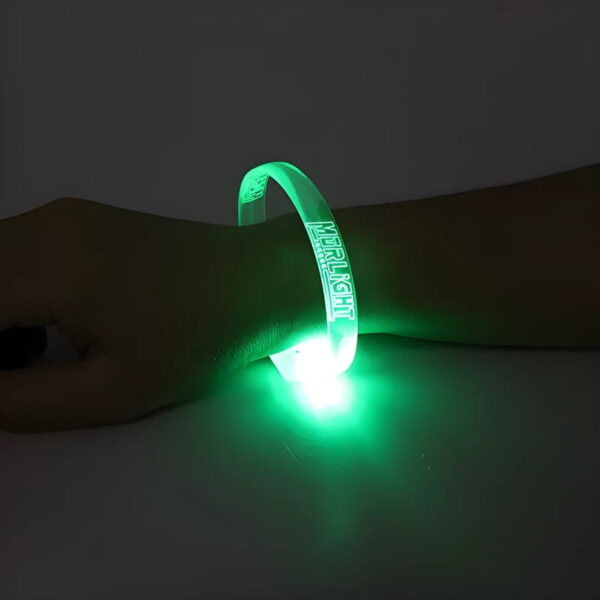 Close up of green LED bracelet glowing on wrist