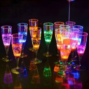 14 different LED champagne glasses on dark bar top glowing bright neon colors