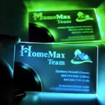 A person holds a glowing business card, showcasing its illuminated design and innovative features.