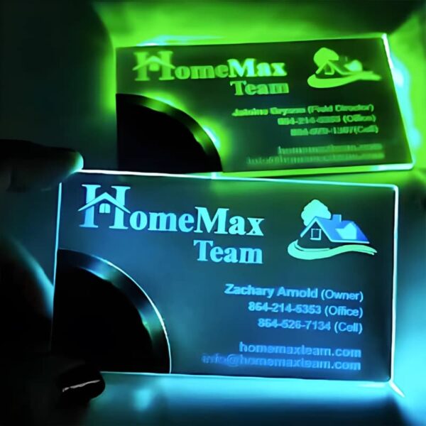 A person holds a glowing business card, showcasing its illuminated design and innovative features.