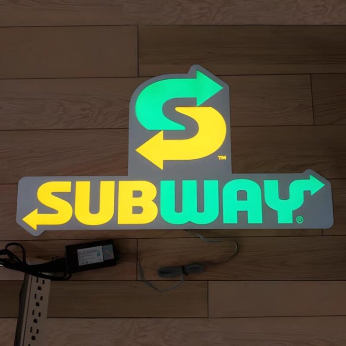 Subway logo lighting up on ground on EL poster