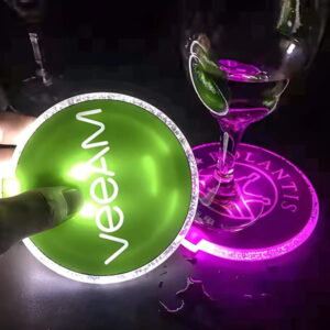 Someone holding custom LED coaster with glass on different LED coaster design in background