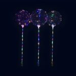 Three light up clear balloons in multi colored LED's, each held by a stick
