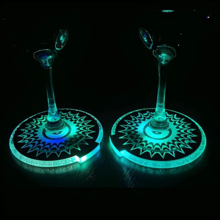 2 wine glasses on light up drink coasters illuminating in green