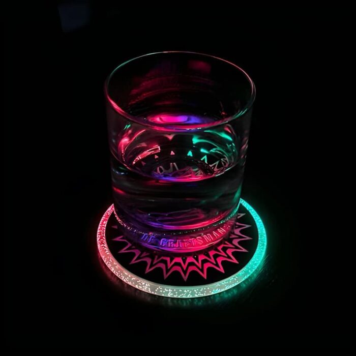 A glass of water illuminated by a colorful light from a light-up drink coaster beneath it