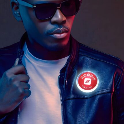 African American male wearing black leather jacket with custom LED pin lighting up bright red and white on his jacket