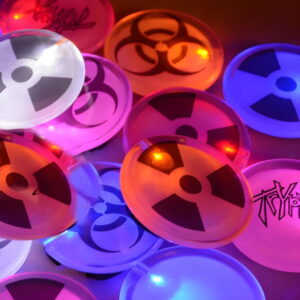 Close up of nuclear design LED pins lighting up pink, orange, blue, red and white