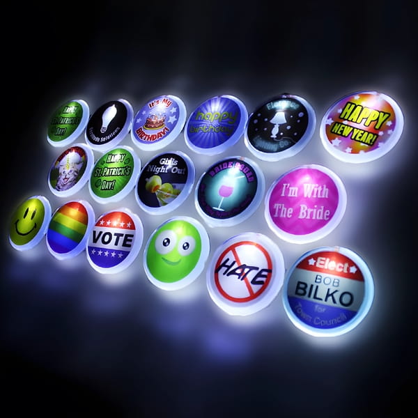 Three rows of various LED pin designs including smiley face, rainbow flag, bridal design, vote and more