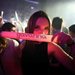 woman in crowded club holding a glowing custom led foam stick