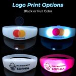 Two silicone remote activated bracelets with printed logo