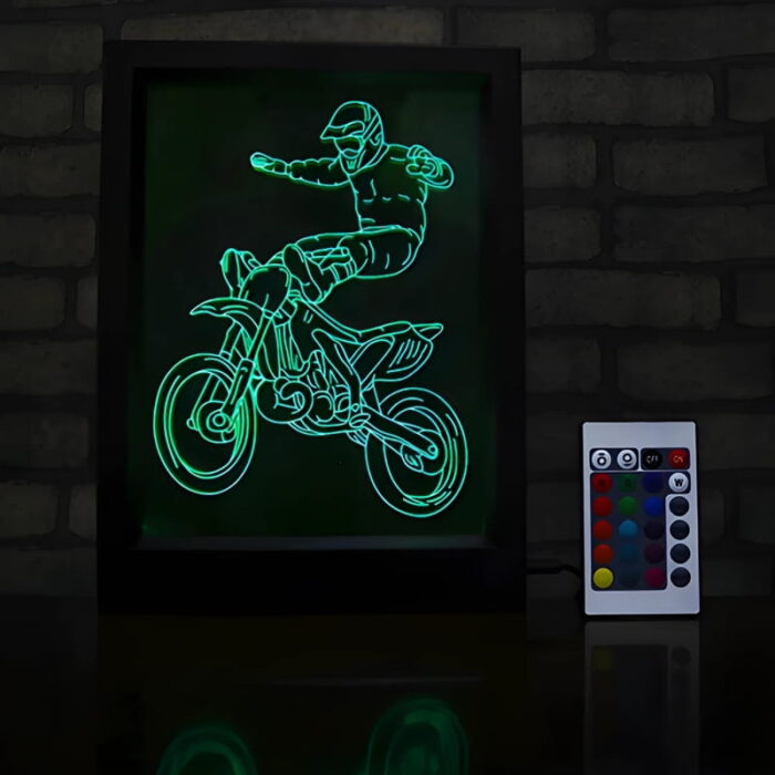 Image of dirt biker on framed acrylic laser engraved design on table with remote control to make it change colors