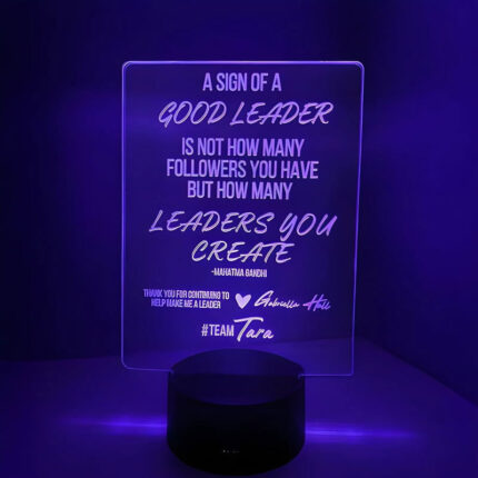 custom laser engraved sign with inspirational quote glowing in purple LEDs