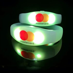 Mastercard logo custom printed onto light up bracelets glowing bright yellow