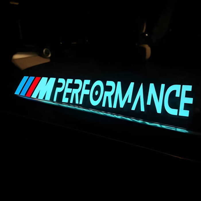 glowing el panel with performance logo illuminating on a car in the dark