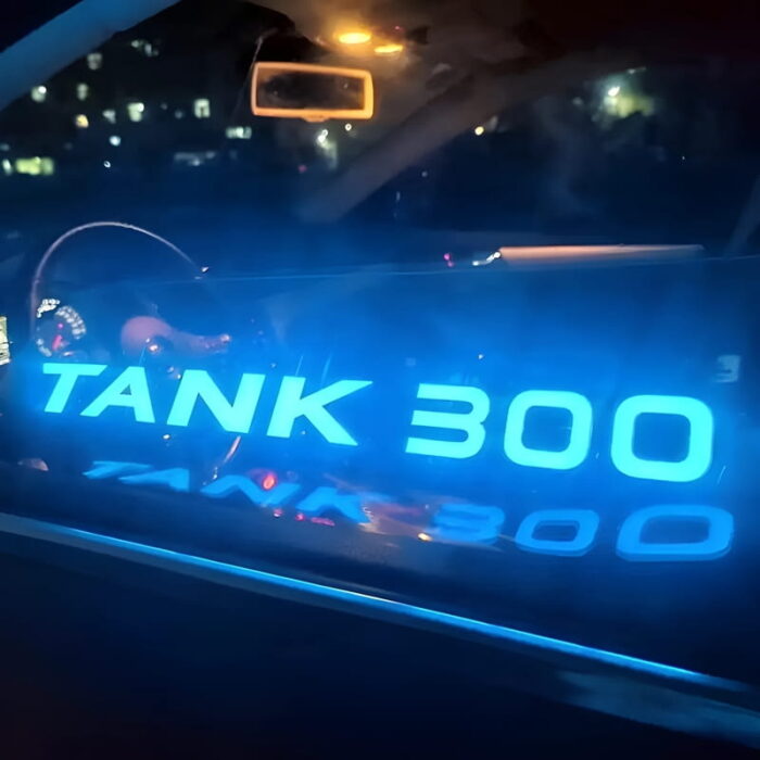illuminated car sticker with the words tank 300 glowing brightly on a car window