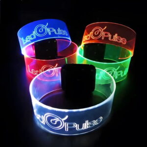 Five of the same engraved design on XL LED wristbands showing logo and text, each