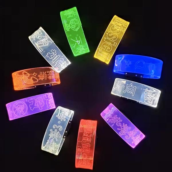 10 different LED wristbands lined up in a circle each glowing a different neon color