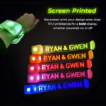 Screen printed led wristbands with "RYAN & GWEN" illuminating in different neon colors