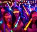 3 girls at a glow party holding light up wands, light up sunglasses under black light