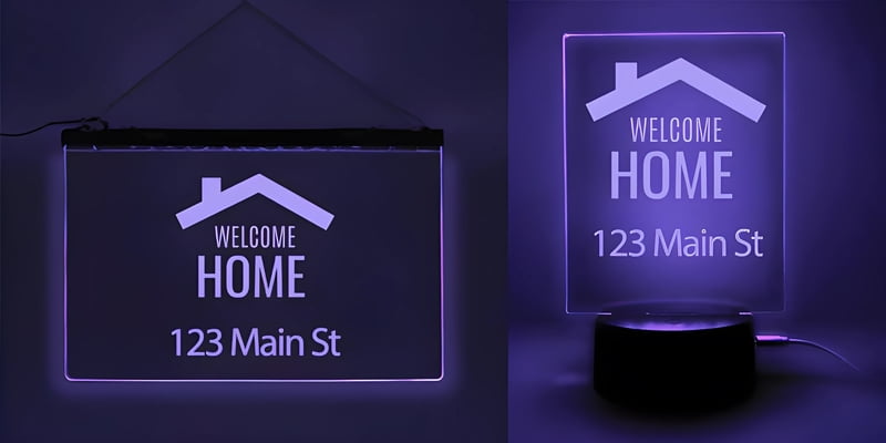 A purple light-up sign saying "Welcome Home," ideal for real estate gifts, shown alongside a table lamp.