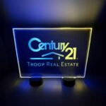 Bright LED acrylic sign for Century 21 real estate, showcasing blue and yellow lights designed for table display