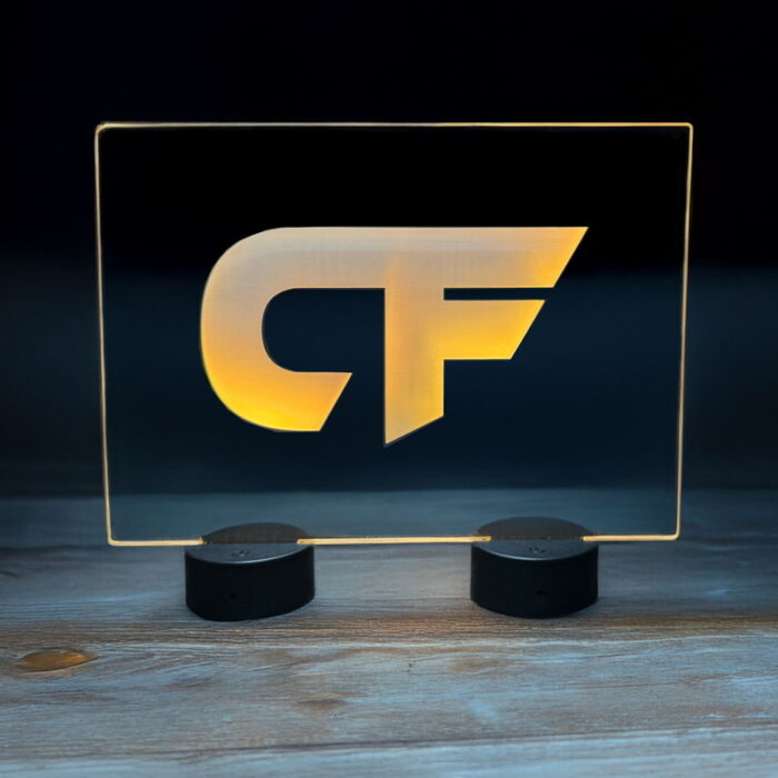 A lighted sign displaying the letters "CF" in a bold, illuminated font against a dark background