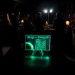 Scan to donate QR code on a light up acrylic card display
