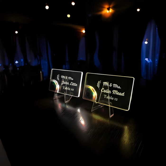 side view of custom acrylic light up table cards at a wedding