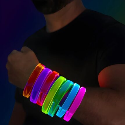 A man showcases bright, colorful light-up bracelets on his wrist