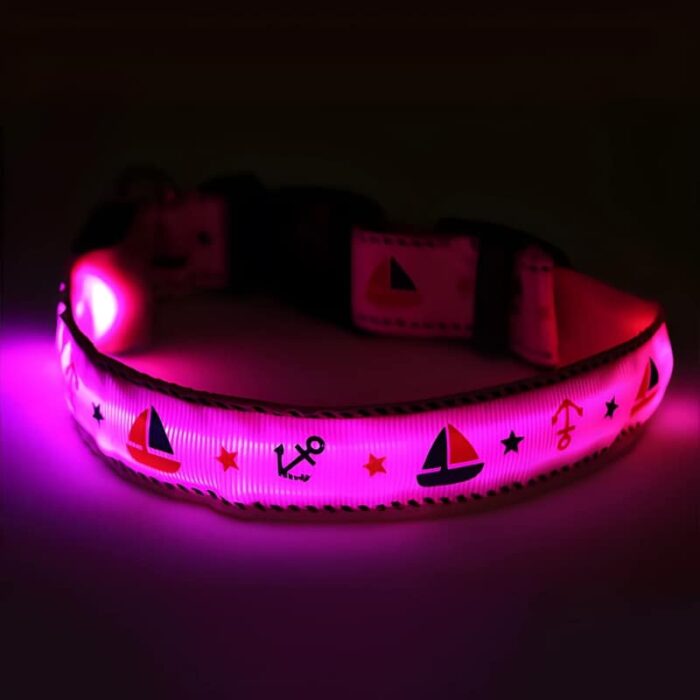 pink LED dog collar lighting up in dark room