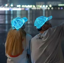 A young couple wearing illuminated glowing all over hats in turquoise