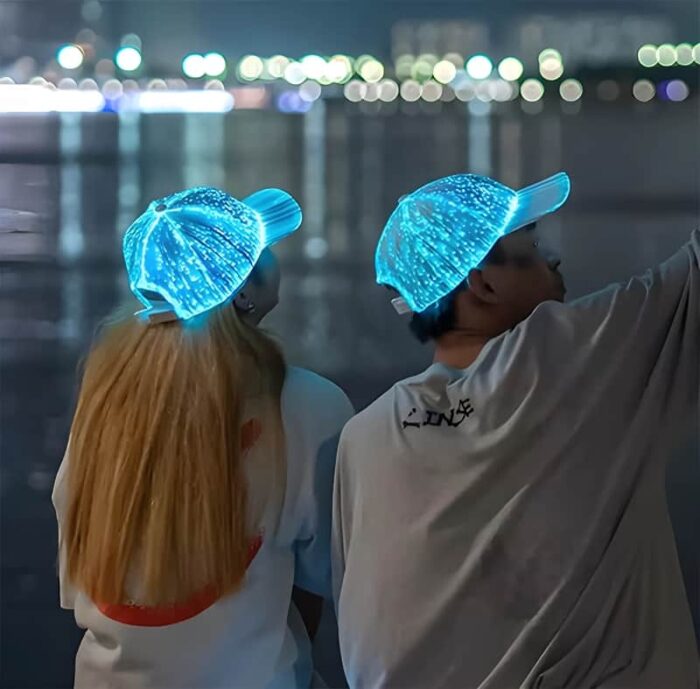 A young couple wearing illuminated glowing all over hats in turquoise